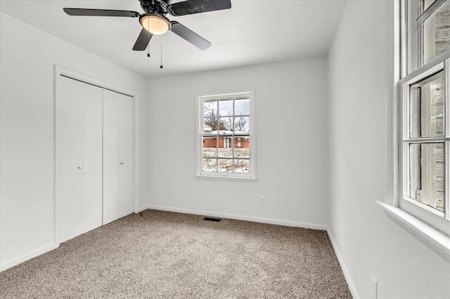 10313 N Mckinley Ave, Oklahoma City, OK 73114 - unfurnished bedroom featuring carpet flooring, baseboards, ceiling fan, visible vents, and a closet