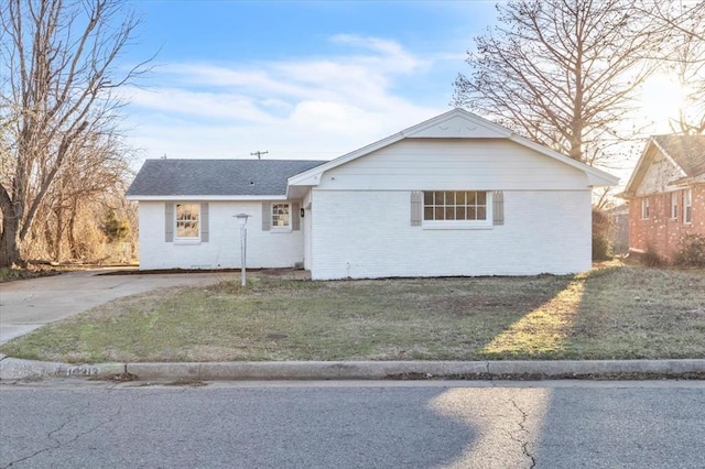 10313 N Mckinley Ave, Oklahoma City, OK 73114 - ranch-style home featuring brick siding, a shingled roof, and a front lawn