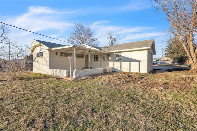 10313 N Mckinley Ave, Oklahoma City, OK 73114 - back of house featuring brick siding and a yard