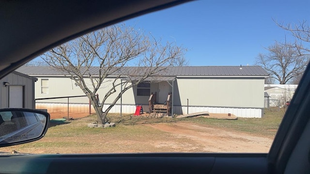 exterior space with metal roof and fence