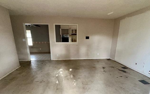 spare room with unfinished concrete floors