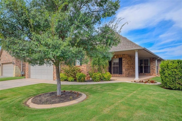 view of front of house featuring a front yard, brick siding, and driveway