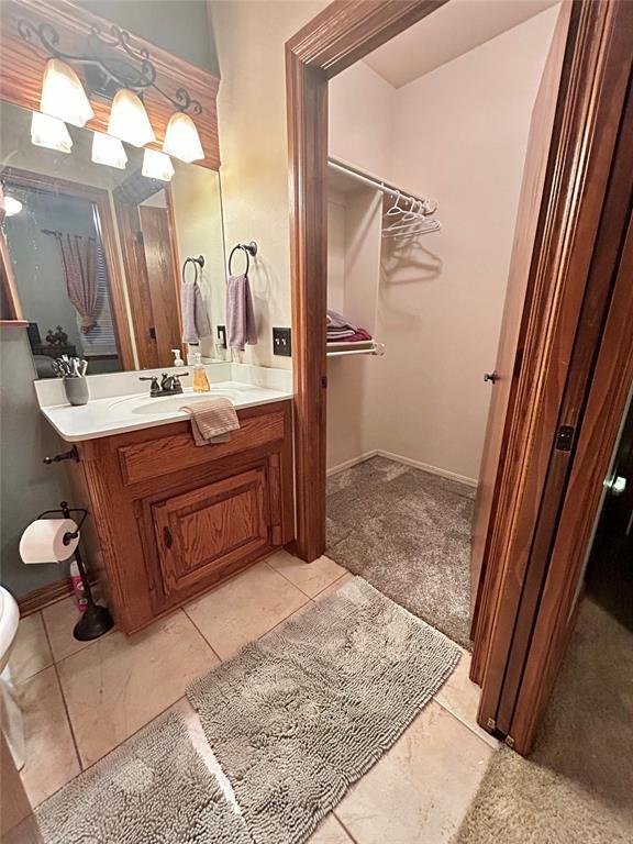 bathroom featuring baseboards and vanity