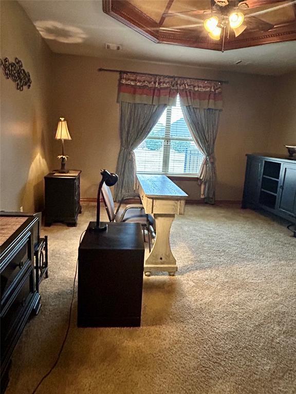 carpeted office featuring a ceiling fan