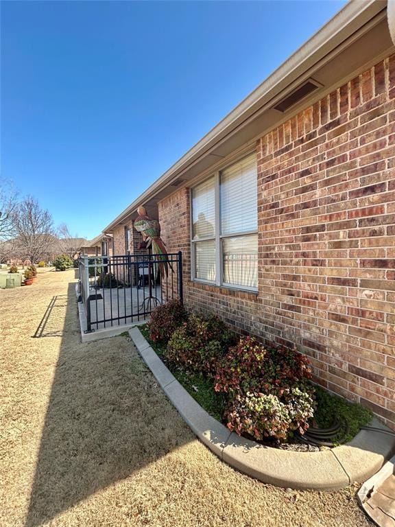 view of side of home featuring brick siding