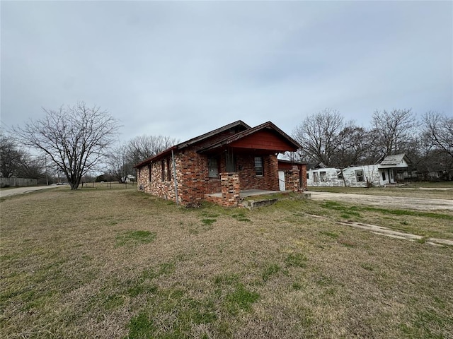 view of home's exterior featuring a yard and brick siding