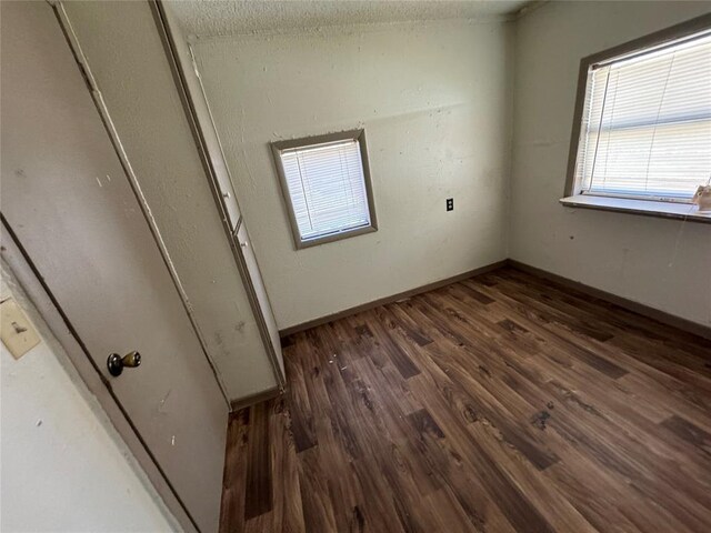 empty room with wood finished floors and baseboards