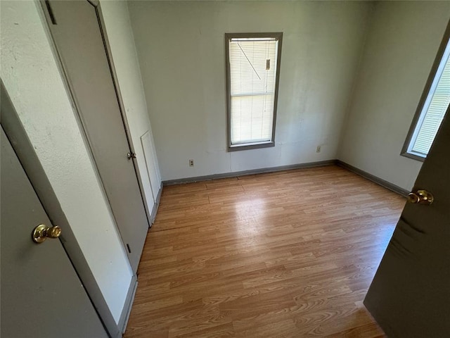 unfurnished bedroom featuring light wood-type flooring and baseboards