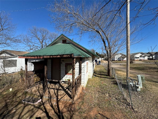 exterior space featuring metal roof and an outdoor structure