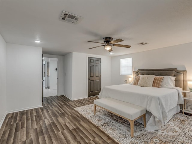 bedroom featuring ceiling fan, wood finished floors, visible vents, and baseboards