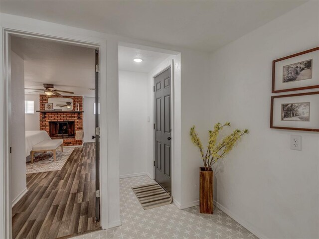 corridor with wood finished floors and baseboards