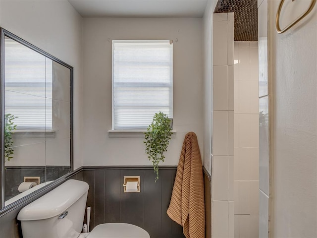 bathroom featuring toilet and wainscoting