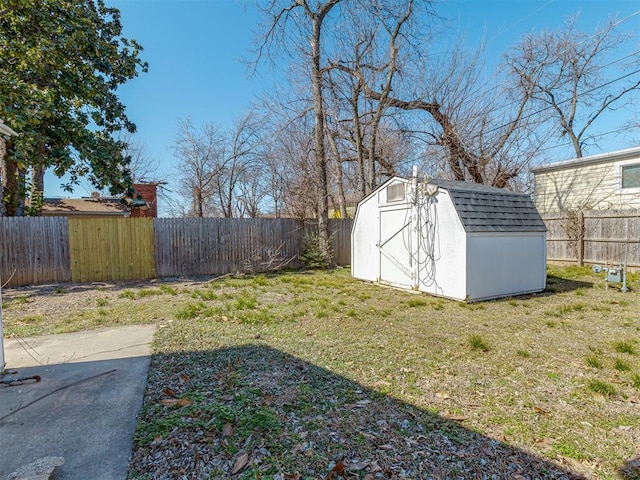 view of yard with an outbuilding, a storage unit, and a fenced backyard