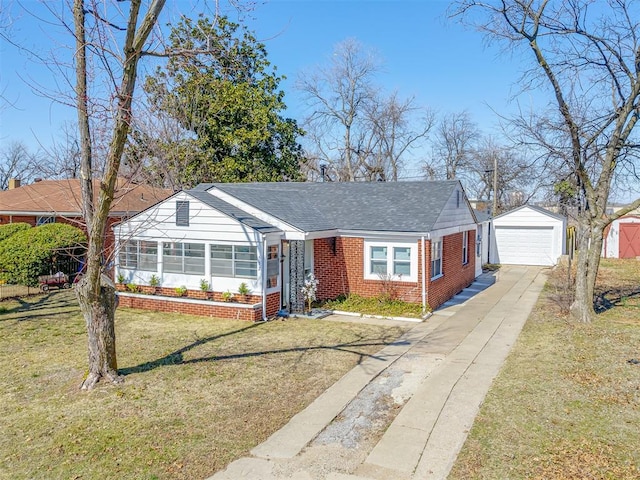 view of front of home with brick siding, a detached garage, a shingled roof, a front yard, and an outdoor structure