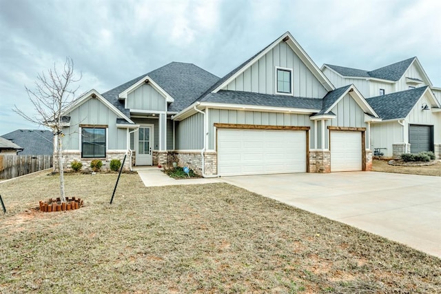 view of front of property featuring board and batten siding, concrete driveway, roof with shingles, and fence