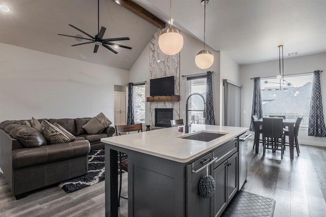 kitchen with dark wood finished floors, open floor plan, light countertops, and a sink