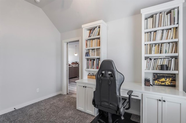 office area featuring lofted ceiling, baseboards, and dark carpet