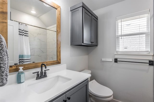 bathroom with toilet, curtained shower, and vanity