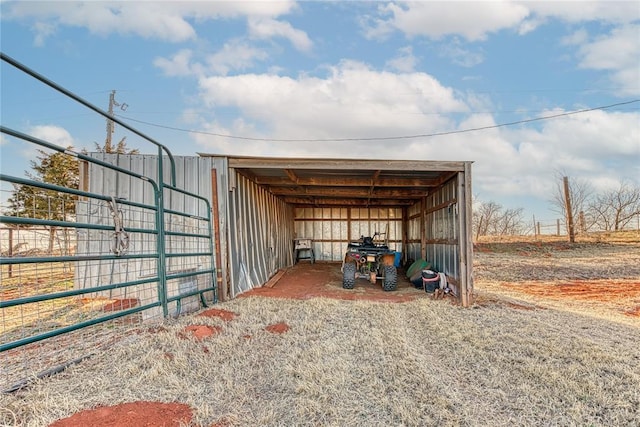 view of outdoor structure featuring a carport and an outbuilding