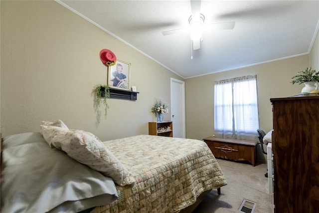 bedroom featuring vaulted ceiling, visible vents, ornamental molding, and light colored carpet