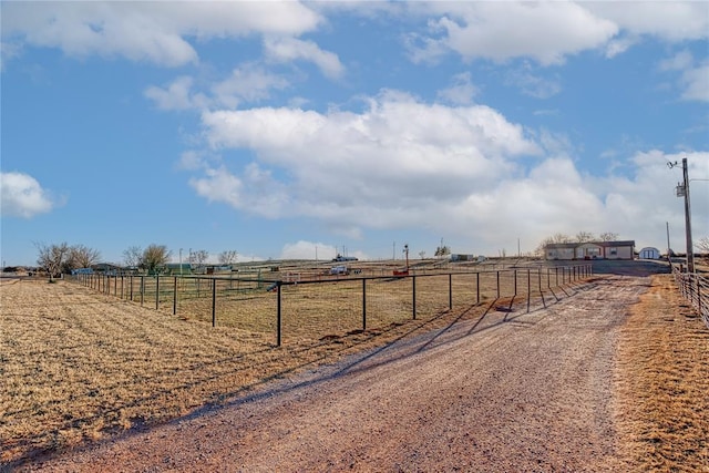 view of street featuring a rural view and dirt driveway