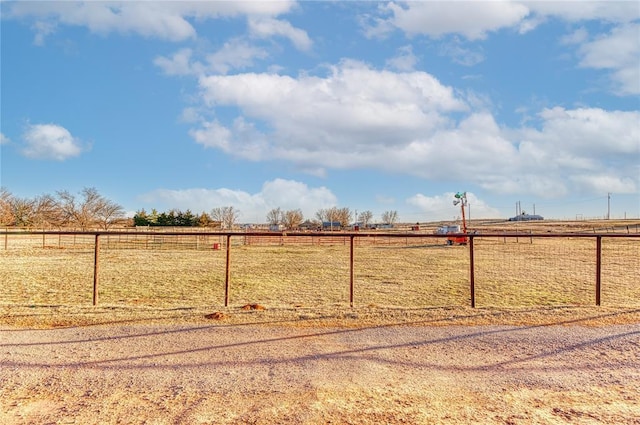 view of yard with a rural view and fence