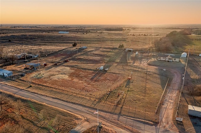 aerial view at dusk featuring a rural view