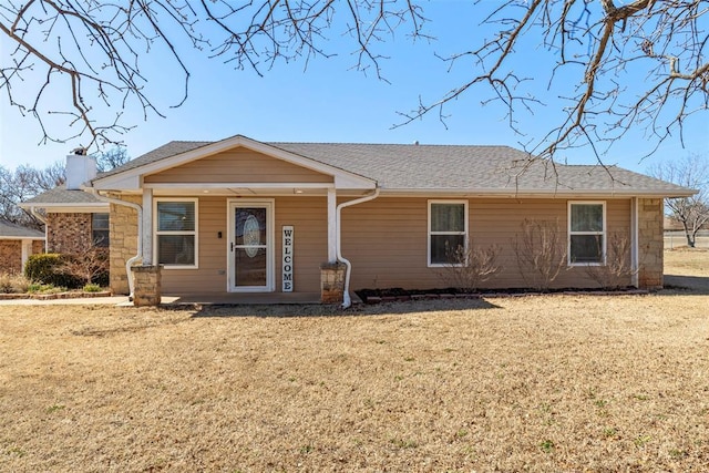 single story home with a front lawn and a chimney