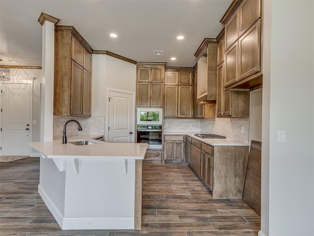 10124 Gentry Xing, Oklahoma City, OK 73169 - kitchen with stainless steel appliances, a peninsula, dark wood-style floors, tasteful backsplash, and recessed lighting