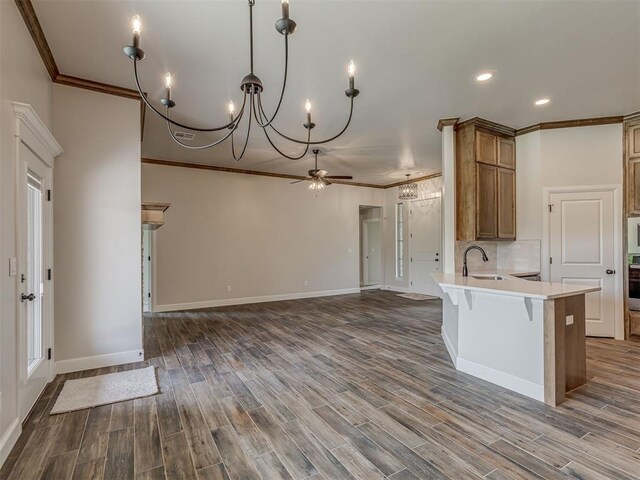 10124 Gentry Xing, Oklahoma City, OK 73169 - kitchen with ornamental molding, a ceiling fan, a chandelier, oven, and light countertops