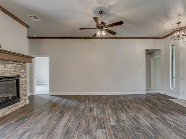 10124 Gentry Xing, Oklahoma City, OK 73169 - unfurnished living room with crown molding, dark wood-style floors, a ceiling fan, a fireplace, and a chandelier