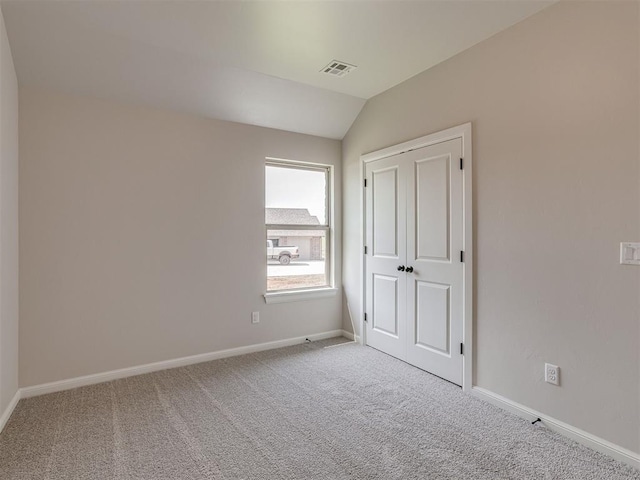 10124 Gentry Xing, Oklahoma City, OK 73169 - unfurnished bedroom with carpet floors and vaulted ceiling