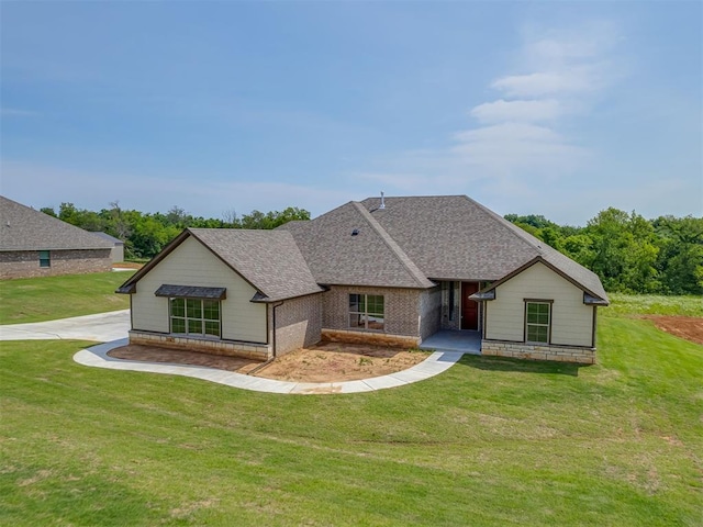 10124 Gentry Xing, Oklahoma City, OK 73169 - view of front of property with a shingled roof, a front yard, and brick siding