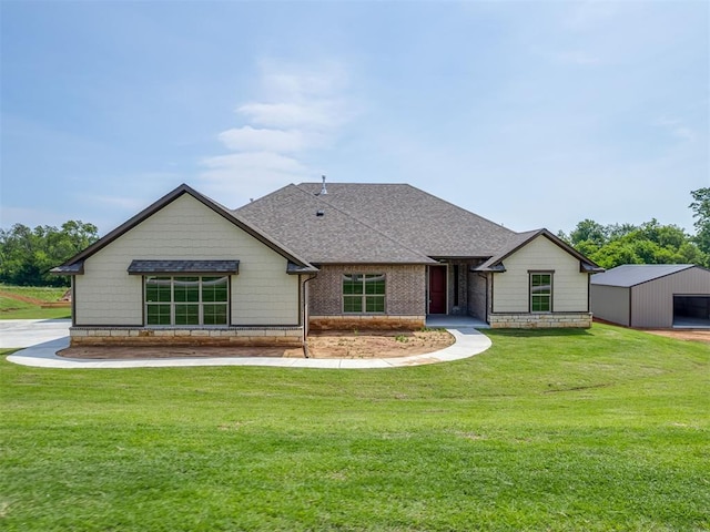 10124 Gentry Xing, Oklahoma City, OK 73169 - view of front of home with roof with shingles, a front lawn, and an outbuilding