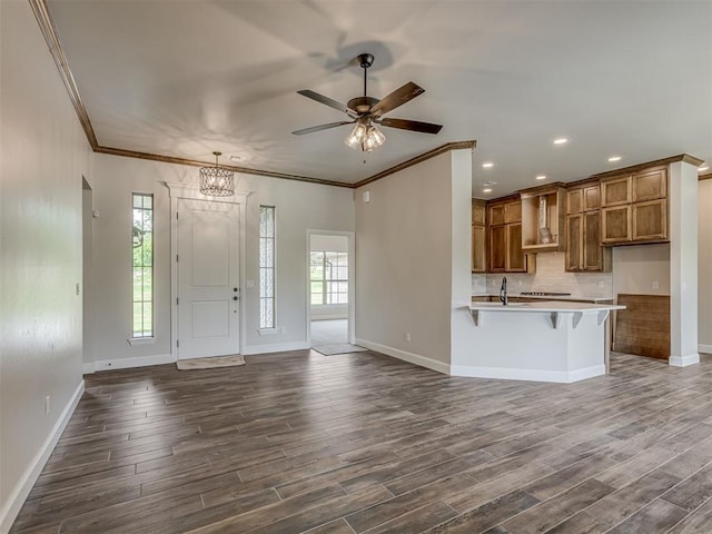 10124 Gentry Xing, Oklahoma City, OK 73169 - entrance foyer with a ceiling fan, dark wood-type flooring, recessed lighting, crown molding, and a chandelier