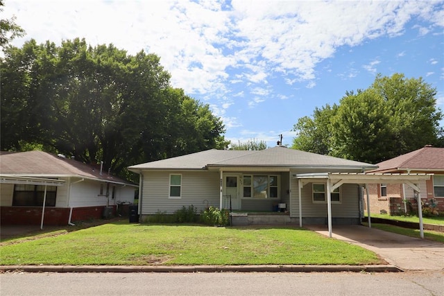 view of front facade with driveway, a front lawn, and a porch