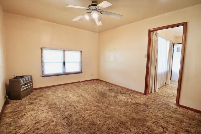 spare room with carpet floors, ceiling fan, and baseboards