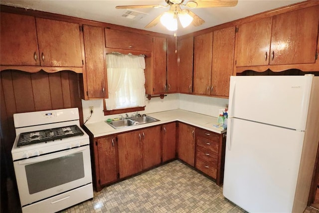 kitchen with white appliances, light countertops, a sink, and ceiling fan