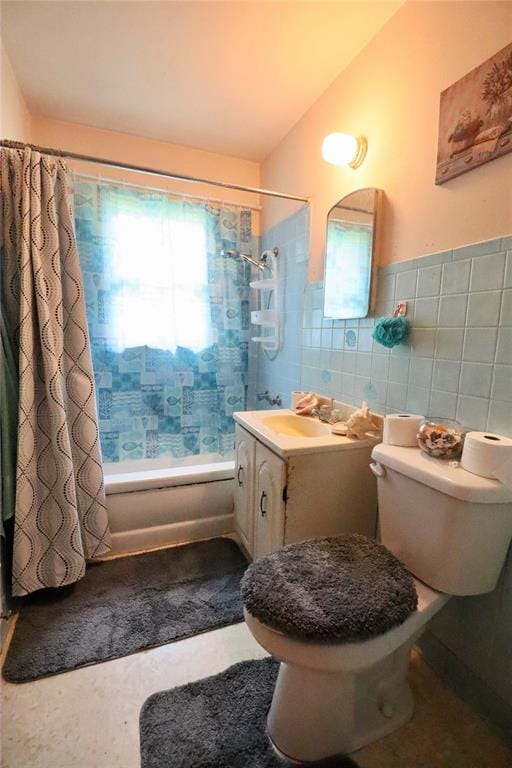 full bath featuring toilet, shower / bath combination with curtain, tile walls, and vanity