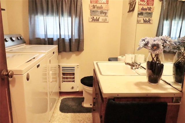 laundry room with a healthy amount of sunlight, laundry area, washer and clothes dryer, and a sink