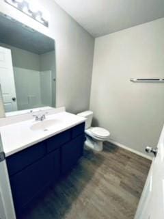 bathroom featuring vanity, wood finished floors, and toilet