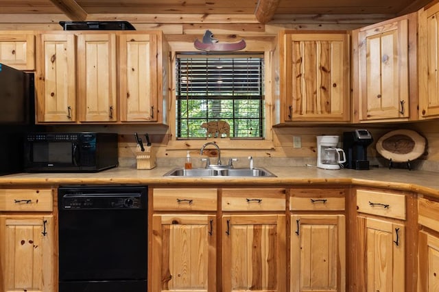 kitchen with black appliances, a sink, and light brown cabinetry