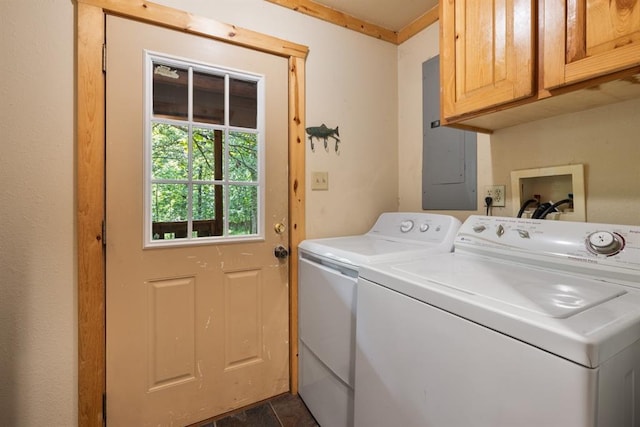 laundry room with electric panel, cabinet space, and separate washer and dryer