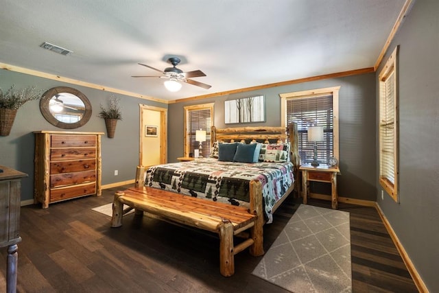 bedroom with ceiling fan, visible vents, baseboards, ornamental molding, and dark wood finished floors