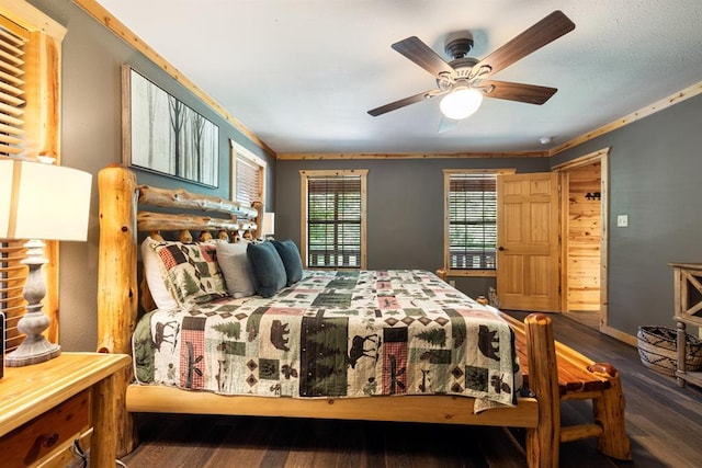 bedroom with ceiling fan, baseboards, and wood finished floors