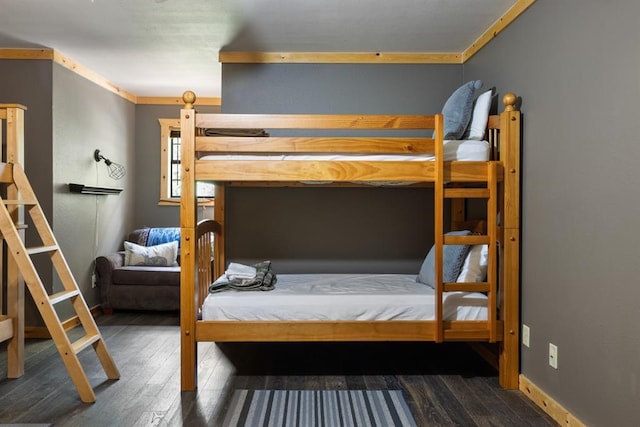 bedroom with wood finished floors and baseboards