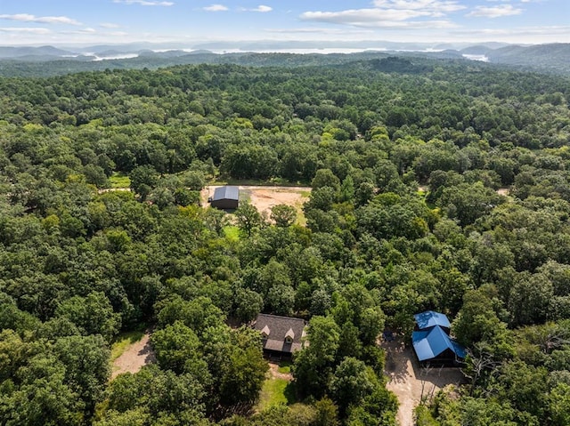 birds eye view of property with a view of trees