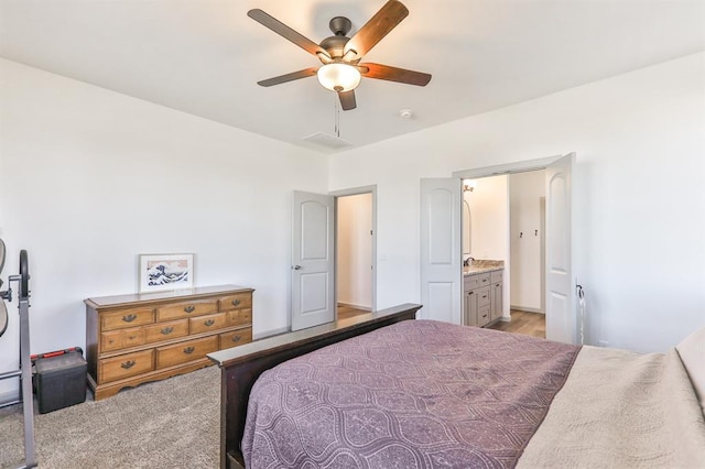 bedroom featuring ceiling fan and ensuite bath