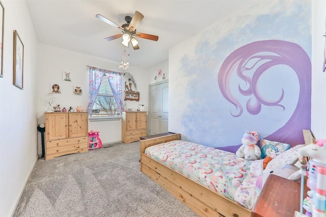 carpeted bedroom with a ceiling fan and baseboards