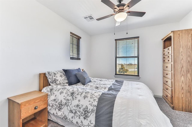 bedroom with a ceiling fan, carpet, and visible vents